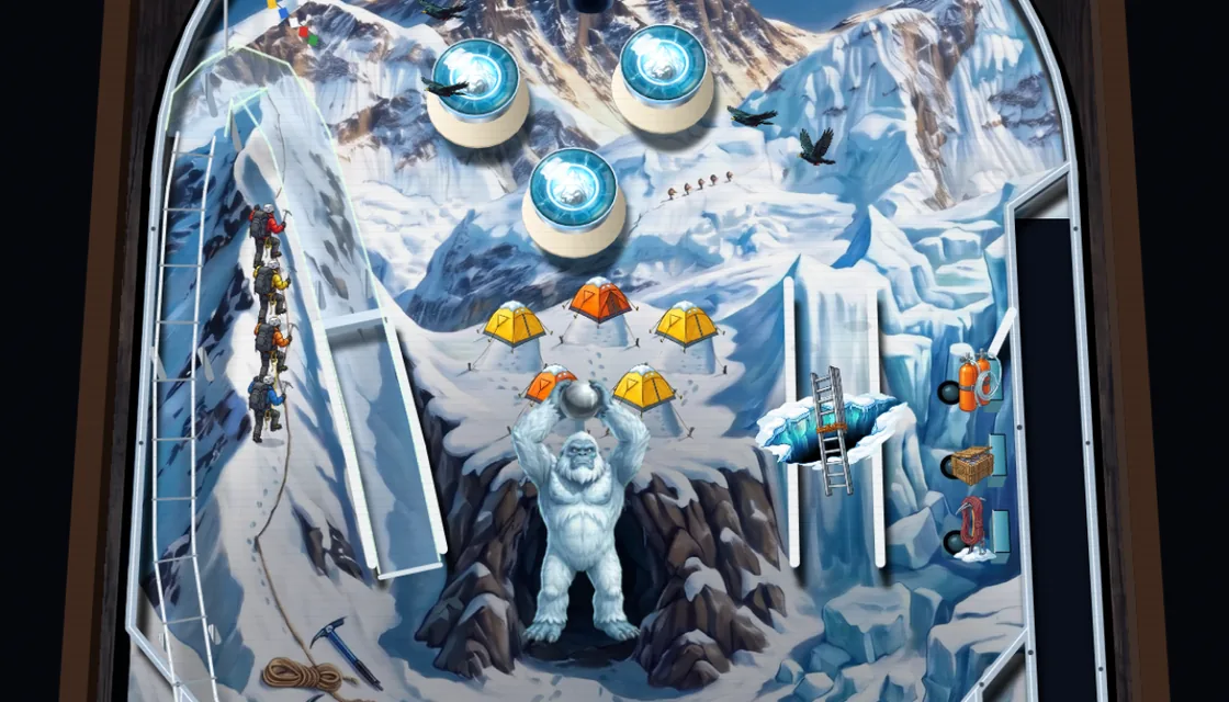 Actual Everest gameplay: the yeti out of his cave holding the ball over his head to throw it, the camp's five tents behind him, the rope team on the ridge to the left, the ladder over the crevasse on the right and choughs flying round the bumpers.
